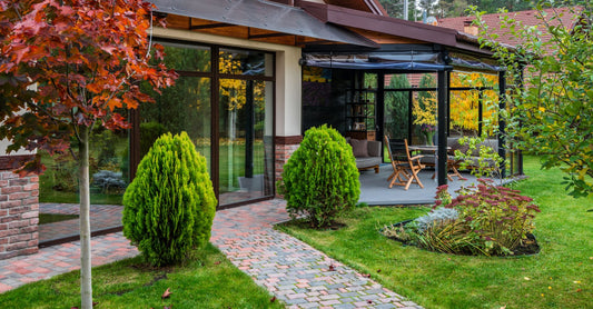 Cozy patio with trees, shrubs, and glass doors