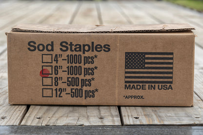 Image of a box of six-inch sod staples from Howell Pathways.